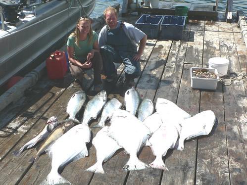 Happy D&D Fishing Charters customers proudly show off their catch.