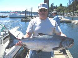 A happy D&D Fishing Charters customer with his big beautiful Chinook salmon